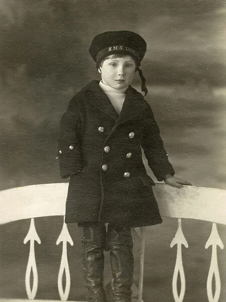 Little Boy in a studio portrait in a HMS Lion sailors cap