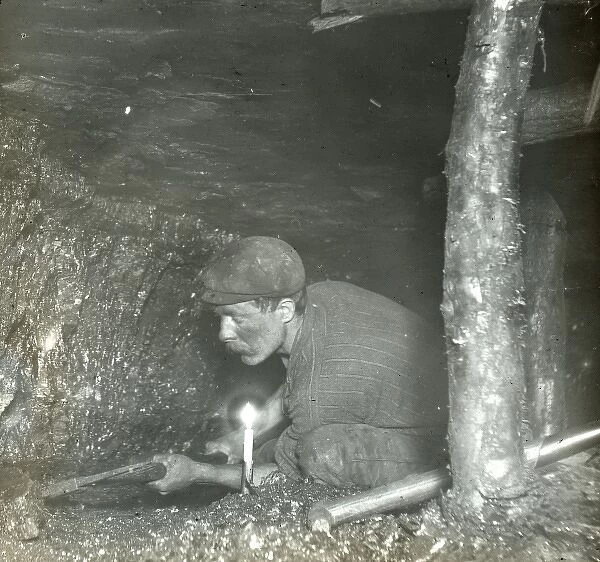 Miner cutting coal in a narrow seam, South Wales