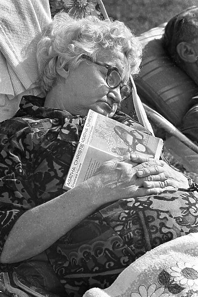 Old lady asleep with paperback book