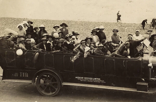 People in a charabanc at the seaside