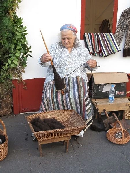 Portugal, Madeira, Funchal: Peasant woman spinning wool