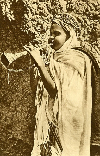 Saharan boy with trumpet, Algeria, North Africa