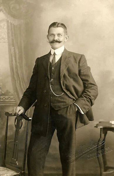 Smartly dressed man with a magnificent moustache
