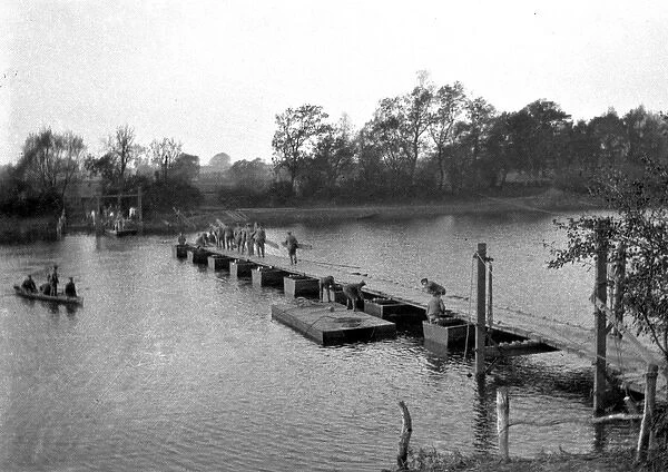 Soldiers constructing Bailey Bridge across river