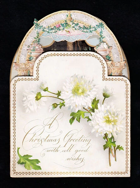 White flowers on an ornate cutout Christmas card