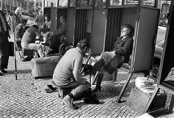 Woman in shoe shine booth Lisbon