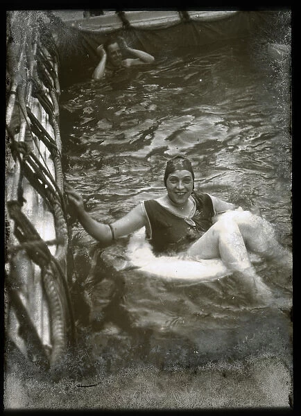 Woman swimming with a lifebelt in a pool
