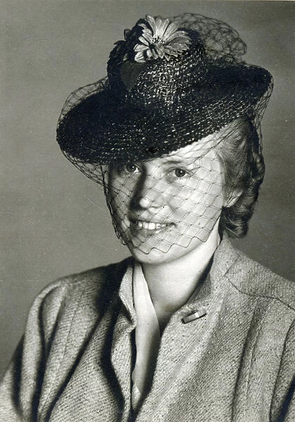 Young German Woman wearing a small black hat with a veil. Date: circa 1930s
