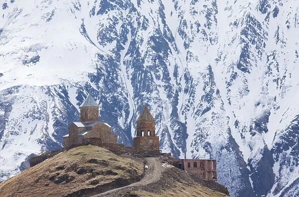 14th century Gergeti Trinity Church (Georgian Orthodox) high in the mountains above Stepantsminda, Kazbegi in the Great Caucasus, Georgia
