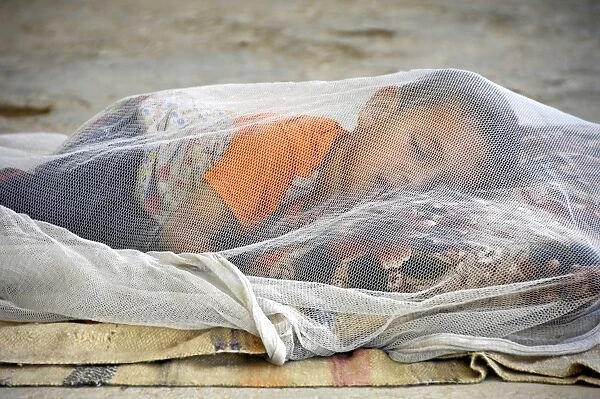 Child under mosqito net, Iraq