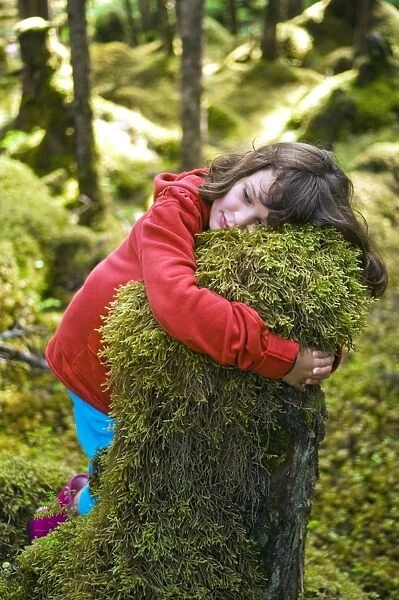 Girl hugging a tree stump