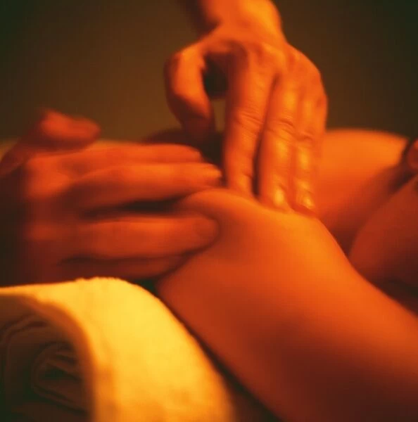 Massage. MODEL RELEASED. Massage. Mans hands massaging a womans shoulder