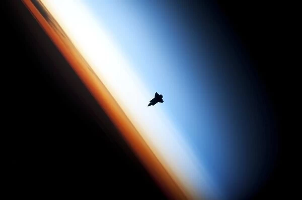 Space shuttle over Earths horizon