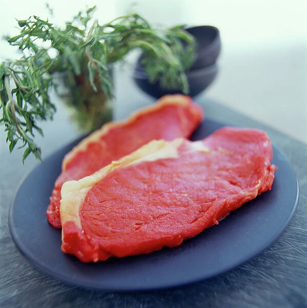 Steak. Two beef steaks on a plate. Red meat is a good source of protein