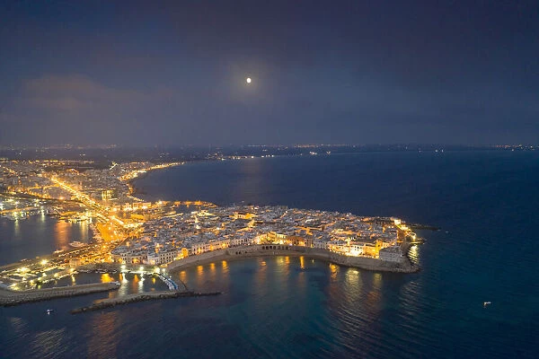 Aerial view of the coastal town of Gallipoli illuminated at night, Lecce province