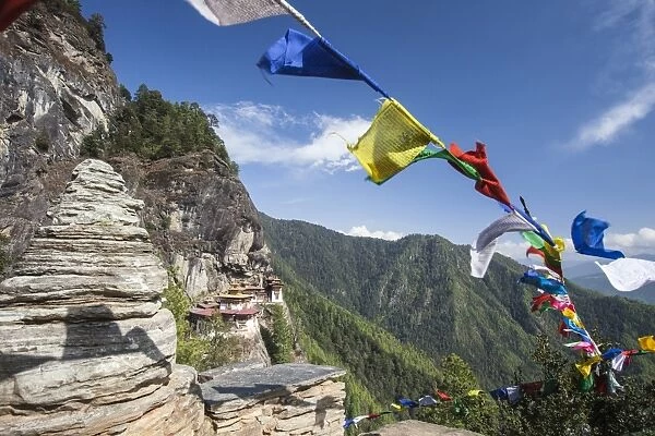 The colorful Tibetan prayer flags invite the faithful to visit the Taktsang Monastery