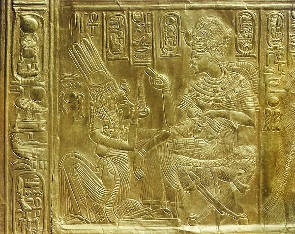 Detail of the exterior of the gilt shrine showing the king pouring perfumed liquid into the queens hand, from the tomb of the pharaoh Tutankhamun, discovered in the Valley of the Kings, Thebes, Egypt, North