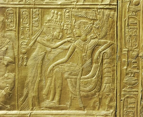 Detail of the exterior of the gilt shrine showing the queen fastening a necklace around the kings neck, from the tomb of the pharaoh Tutankhamun, discovered in the Valley of the Kings, Thebes, Egypt, North