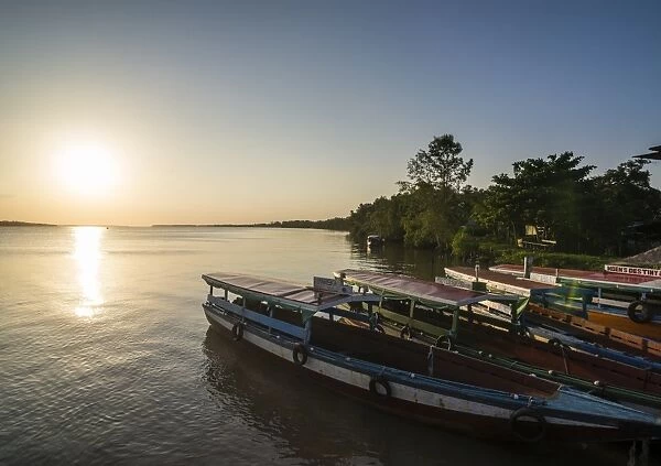 Fishing boats at sunset on the Suriname River near Paramaribo, Surinam, South America