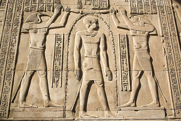 Gods Thoth on left and Haroeris on right with the Pharaoh in the centre, Wall Reliefs