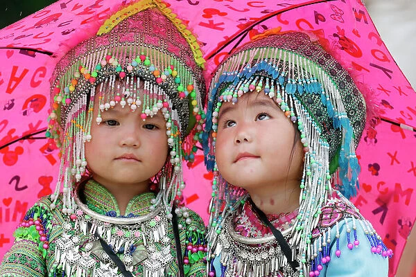 Hmong children under umbrella in the monsoon (rainy) season, Sapa, Vietnam, Indochina