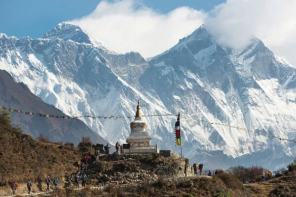 Hoards of trekkers make their way to Everest Base Camp, Mount Everest is the peak on the left