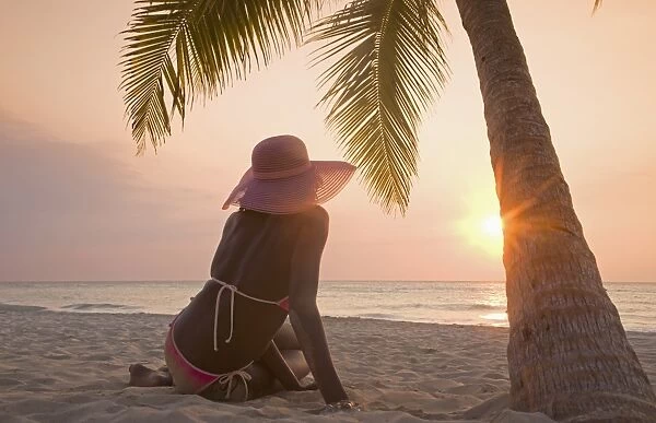 Jamaican woman on beach at sunset
