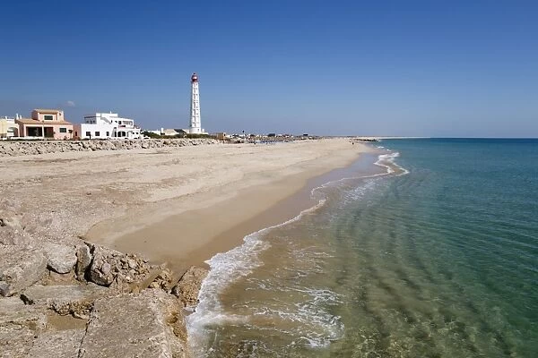 Lighthouse and beach of Ilha do Farol, Culatra barrier island, Olhao, Algarve, Portugal