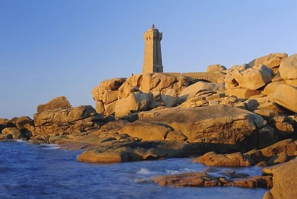 Lighthouse and pink granite rocks at sunset, Ploumanach, Cotes d Armor