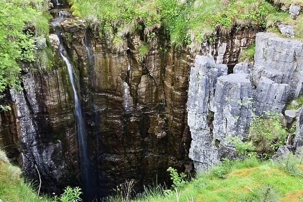 Limestone formations and waterfall at Buttertubs on the Pass from Wensleydale to Swaldale, Yorkshire Dales, Yorkshire, England, United Kingdom, Europe