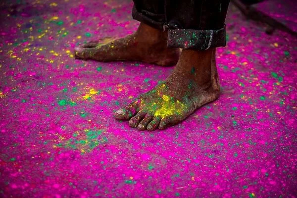 Mans bare feet during the color pigment throwing festival, Holi Festival, Vrindavan