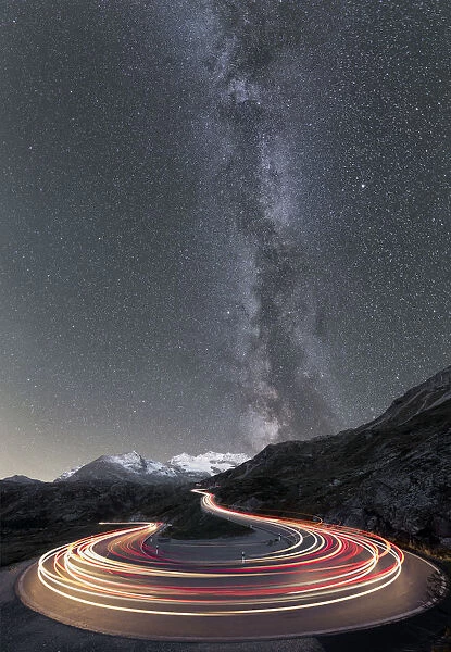 Milky Way and lights of car traces, Bernina Pass, Poschiavo Valley, Engadine, Canton of Graubunden