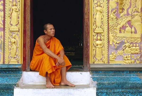 Monk in the doorway of Wat Xieng Thong