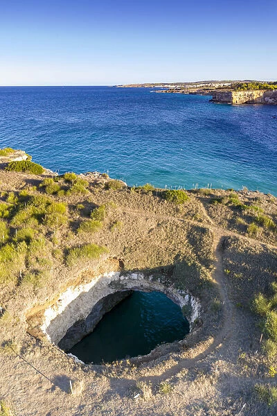 Natural stone arch and open grotto framed by turquoise sea, Otranto, Lecce province
