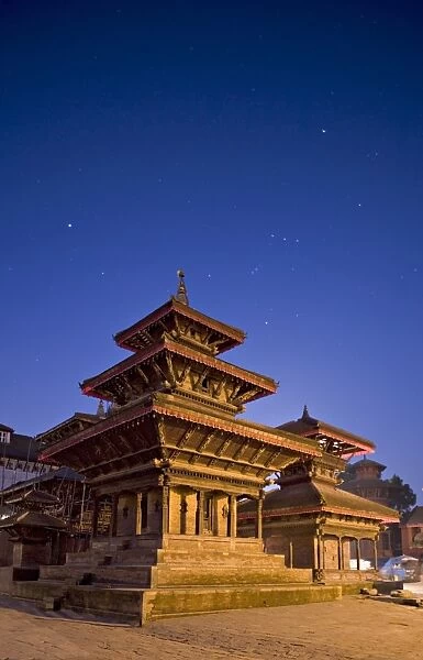 Orion in sky at dawn above triple roofed pagoda temple