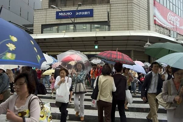 Pedestrians crossing in the rain