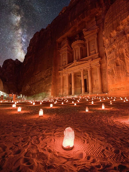 Petra Treasury (El Khazneh) by night illuminated by small lanterns and the Milky Way in the sky, Petra, UNESCO World Heritage Site, Jordan, Middle East