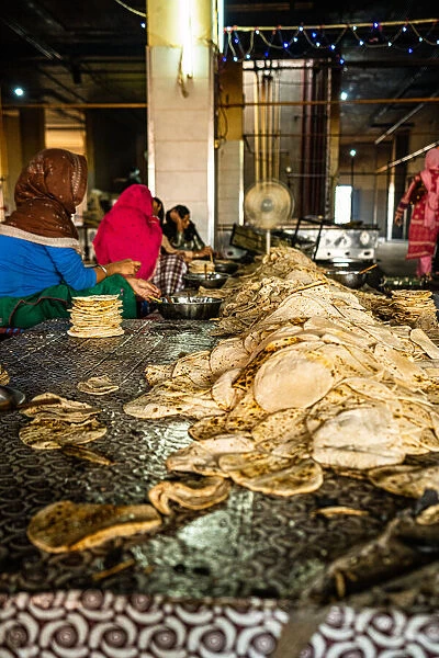 A pile of fresh roti being sorted at the Golden Temple, Amritsar, Punjab, India, Asia