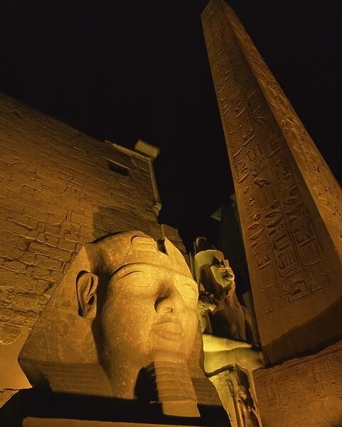 Ramses II and the Obelisk at Luxor Temple, illuminated at night, Luxor