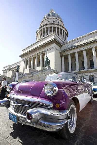 Restored classic American car parked outside The Capitilio, Havana, Cuba