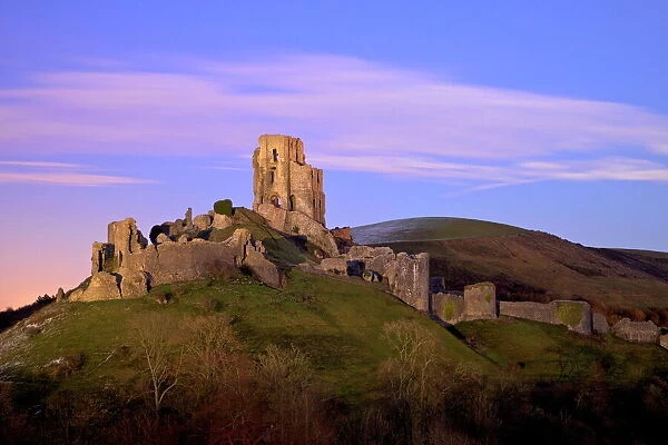 The ruins of the 11th century Corfe Castle after sunset, near Wareham, Isle of Purbeck