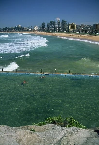 Salt water swimming pool with swimmers, Manly Beach, Sydney, New South Wales