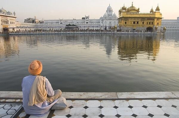 Sikh pilgrim sitting by holy pool