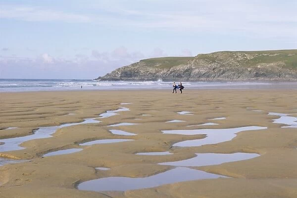 Surfers walking on beach, Holywell Bay, Cornwall, England, United Kingdom, Europe
