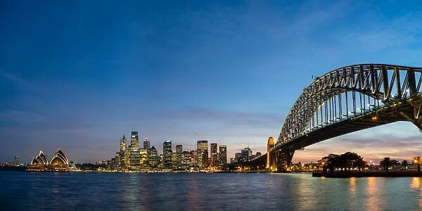 Sydneys iconic buildings lit up as dusk settles over the city, Sydney, New South Wales