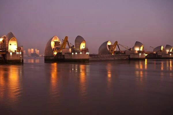 Thames Barrier and Canary Wharf at dawn, London, England, United Kingdom, Europe
