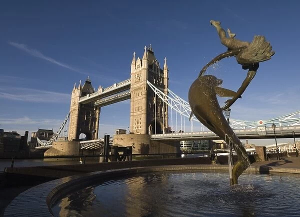 Tower Bridge and the Girl with a Dolphin sculpture, River Thames, London, England
