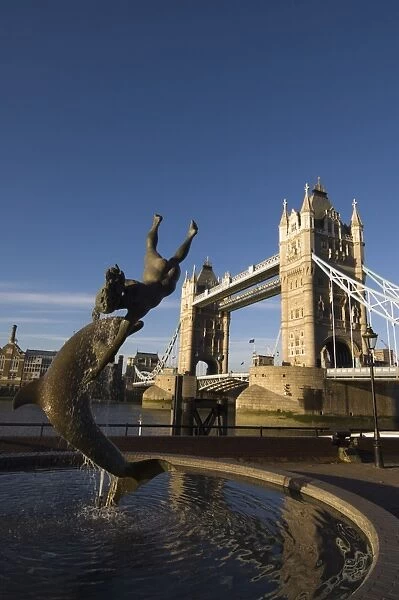 Tower Bridge and Girl with a Dolphin statue, River Thames, London, England
