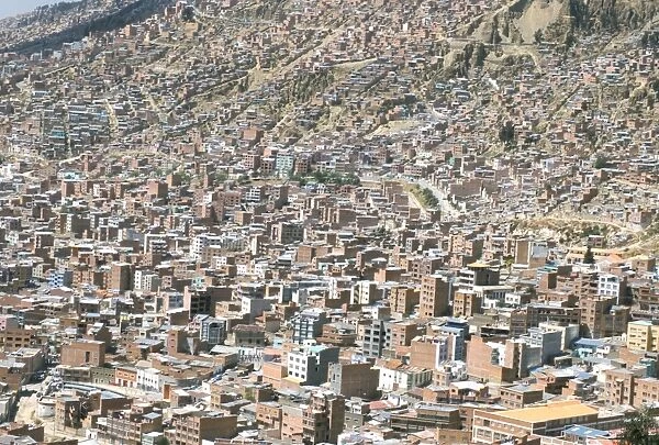View across city from El Alto, of suburb houses stacked up hillside, La Paz, Bolivia