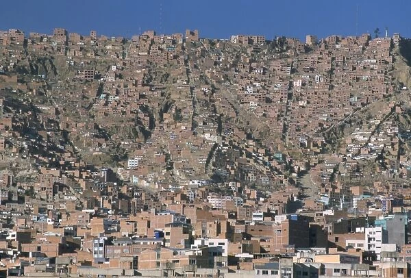 View across city from El Alto, of suburb houses stacked up hillside, La Paz, Bolivia